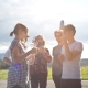 Picture of five friends having fun with funny face masks